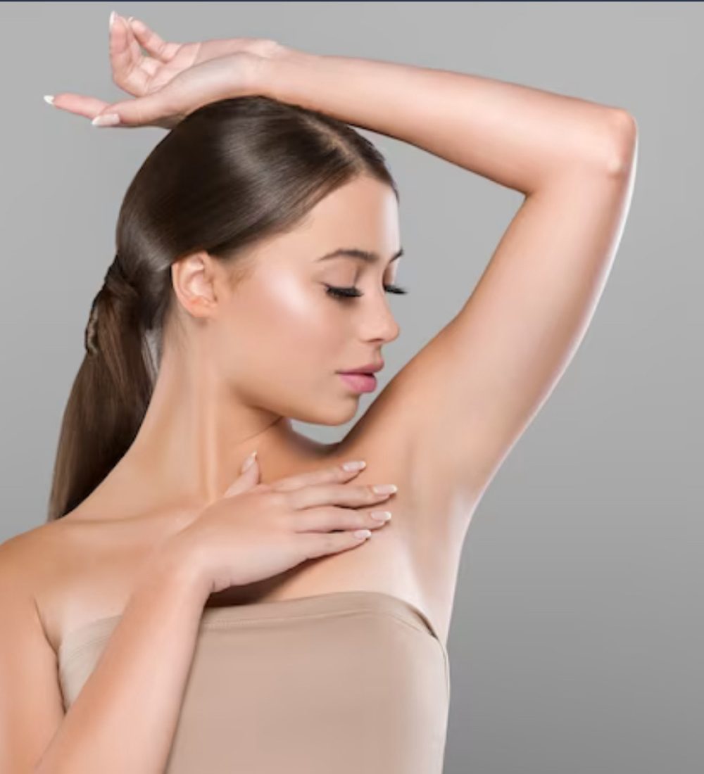 a girl showing raser hair removed armpit
