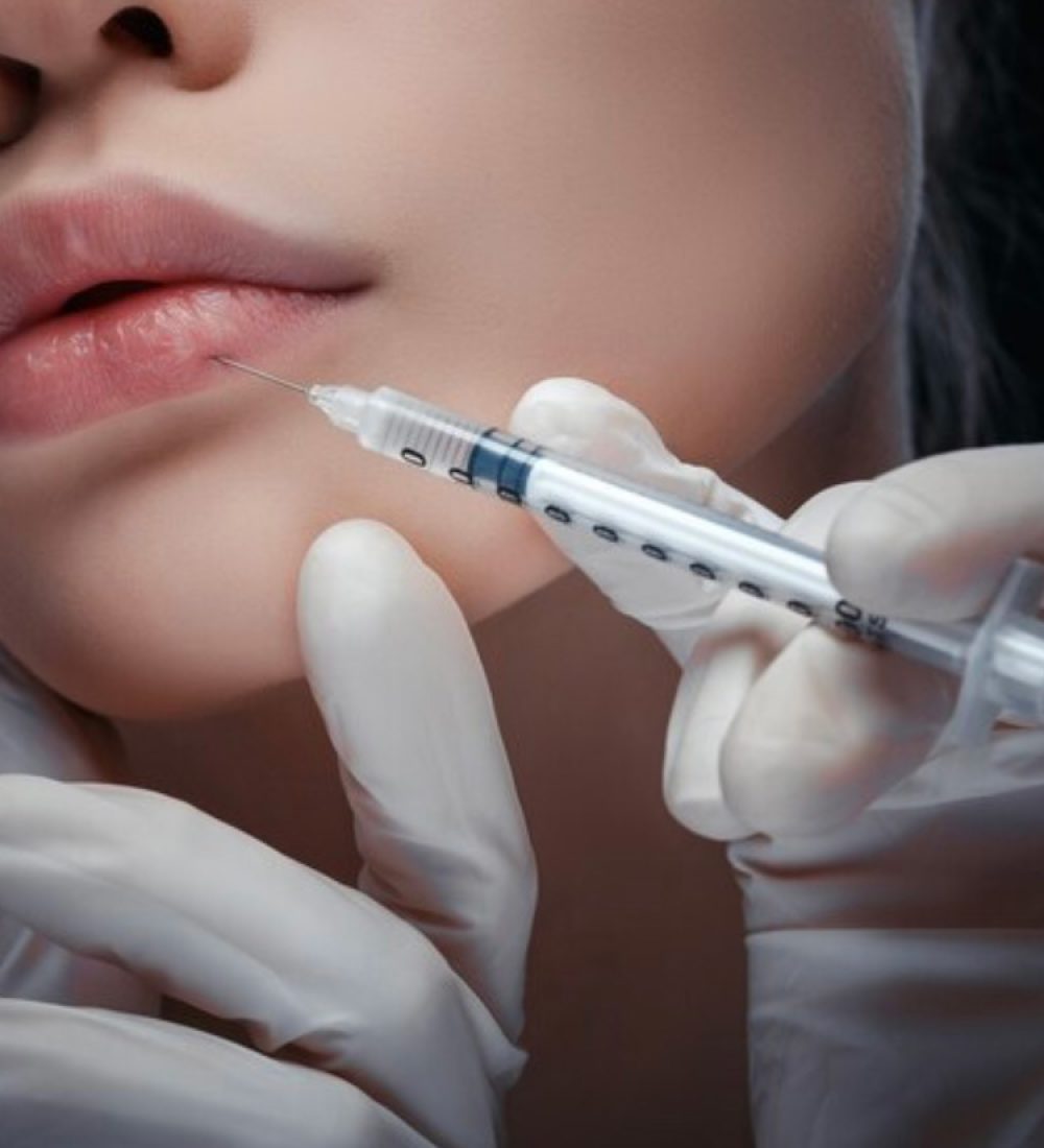 hands with glows, filling lips of women with injection